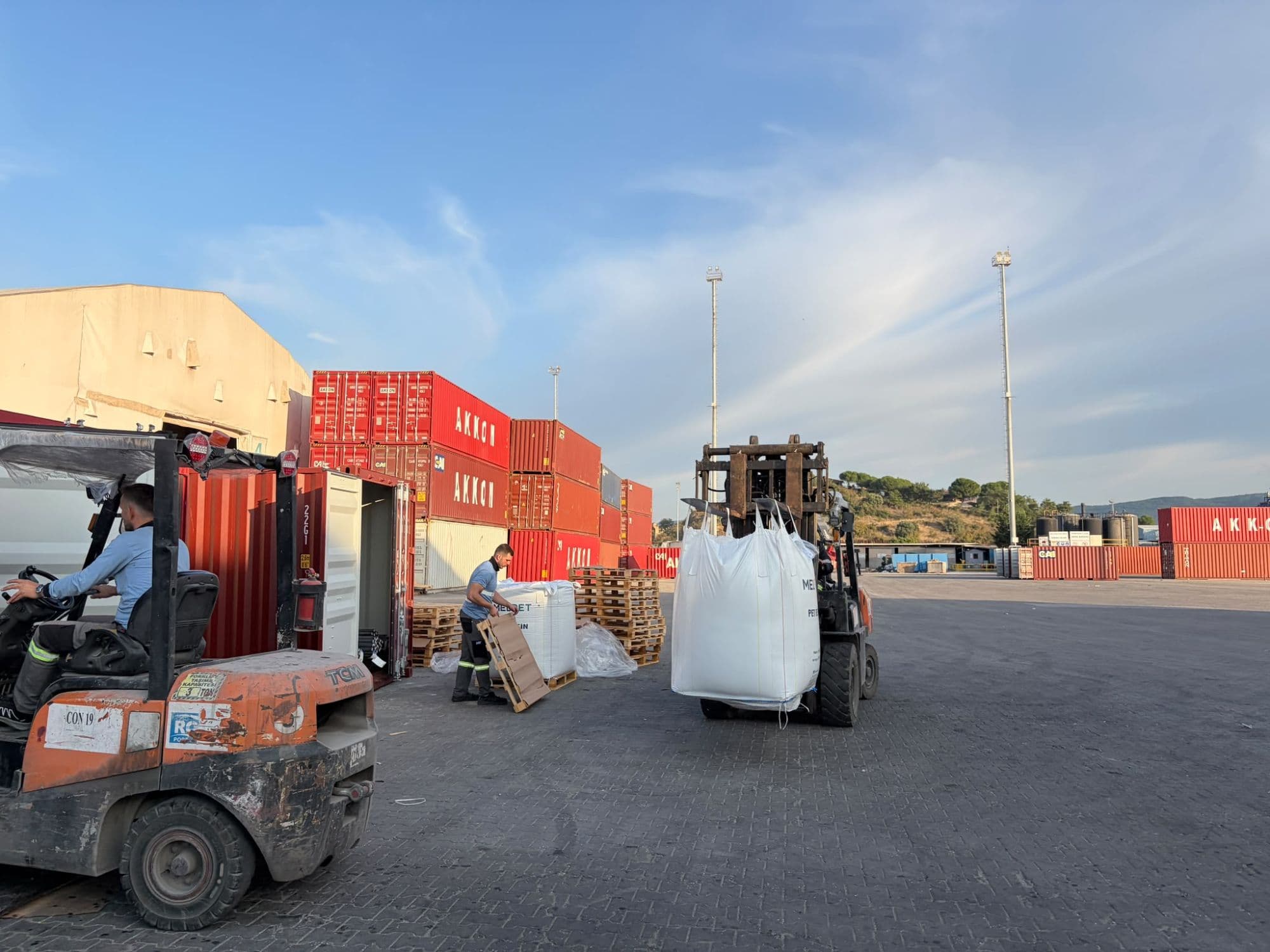 Yard operation: empty pallets are cleared as bags are moved to the container. The bag tally is kept at this stage.