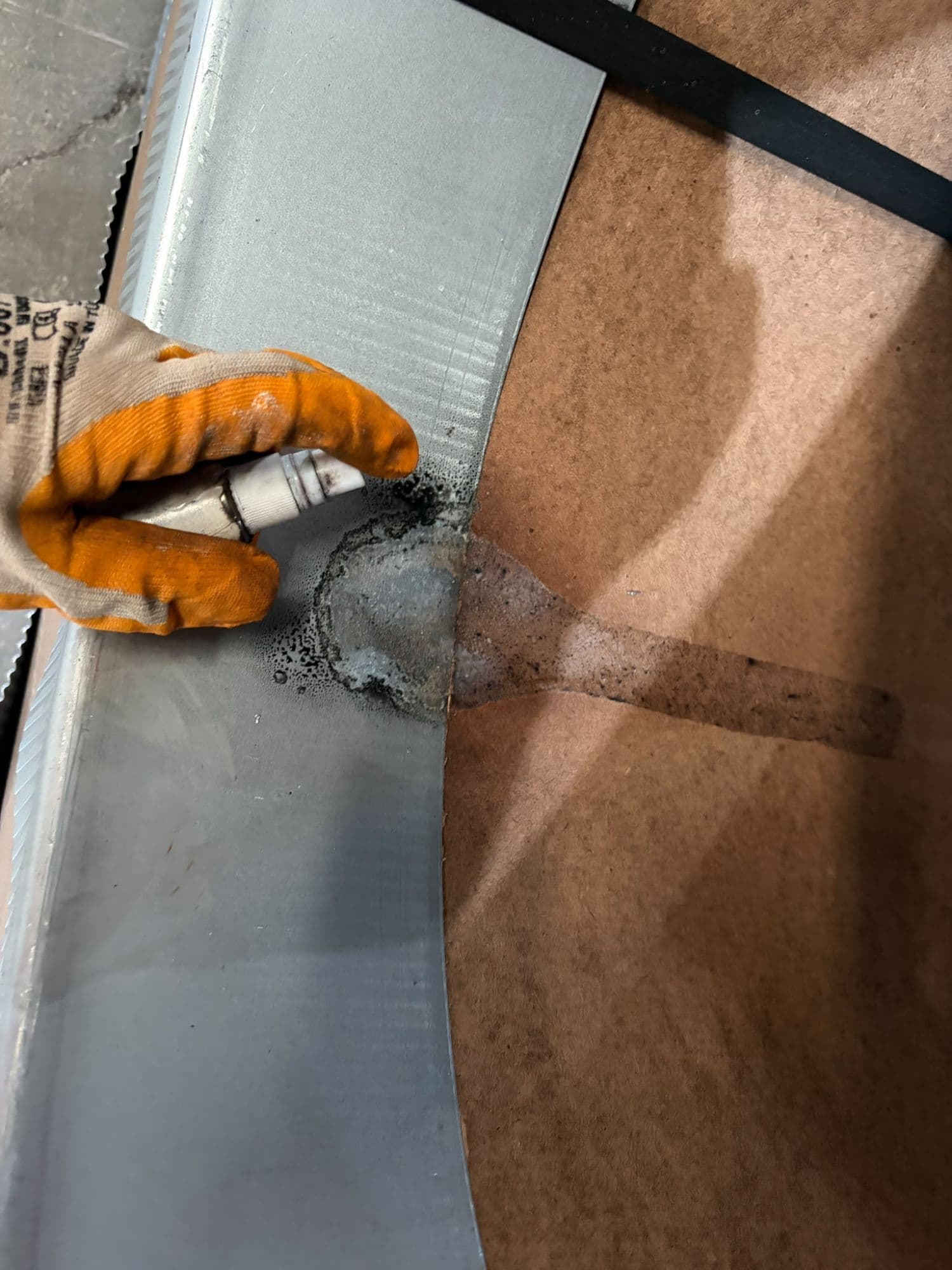 Testing a wet mark on the wrapping paper and coil surface. Wet packing means corrosion can continue underneath it; early detection prevents the damage from growing.