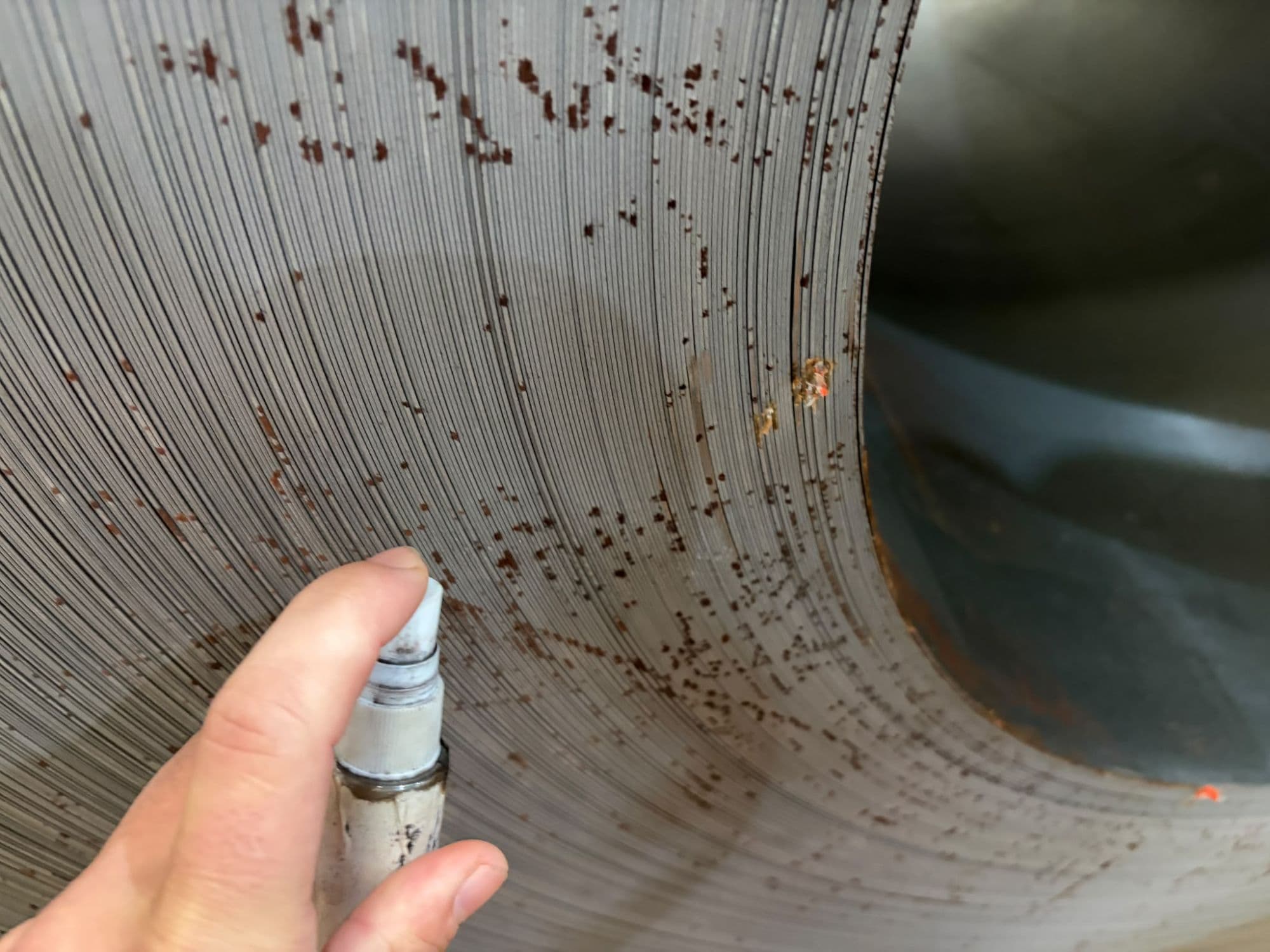 Testing widespread rust staining on the coil edge face. Corrosion moving in from the edge may indicate water between the wraps and helps determine the extent of damage.